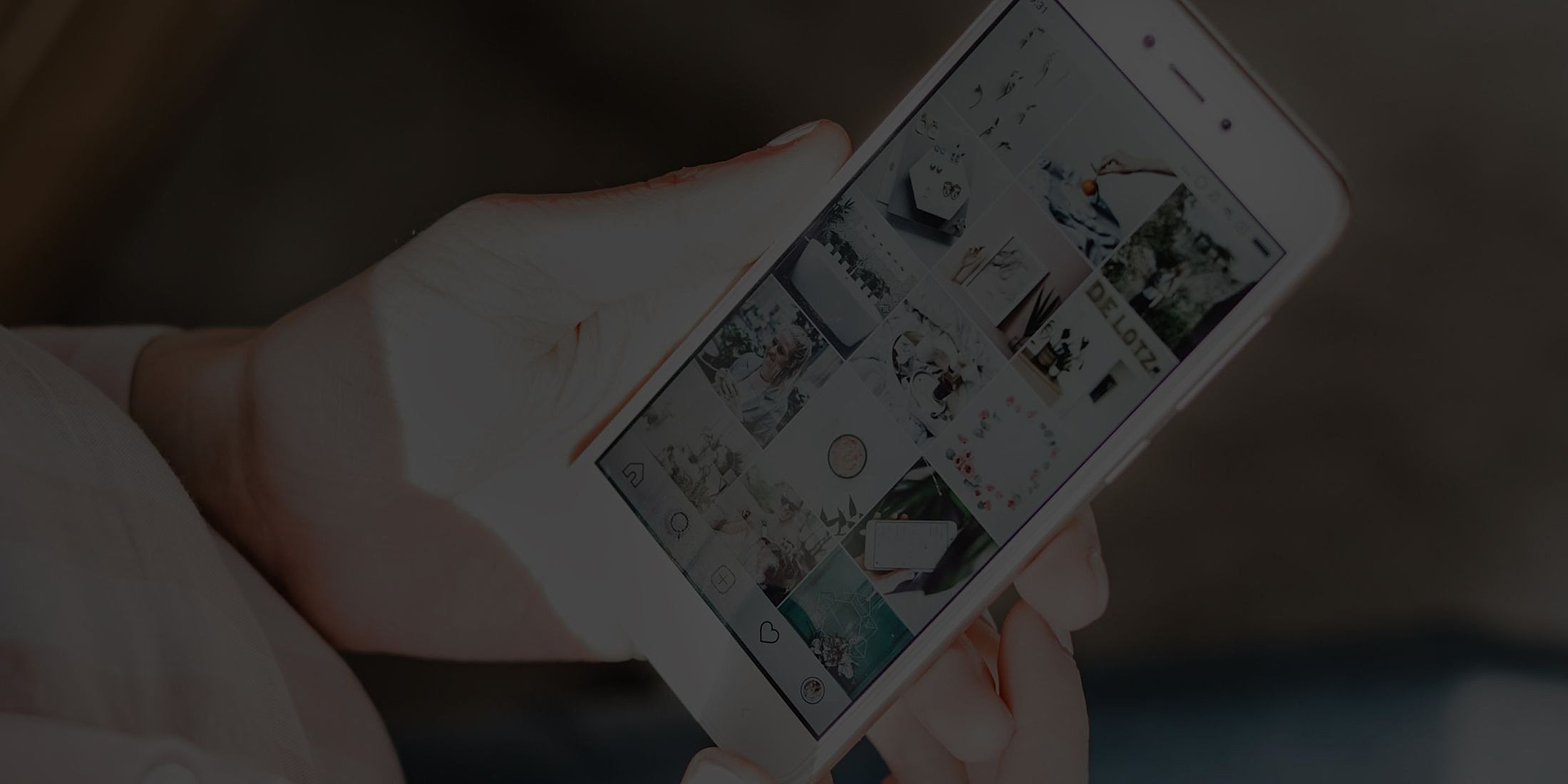 Person holding smartphone displaying social media application.